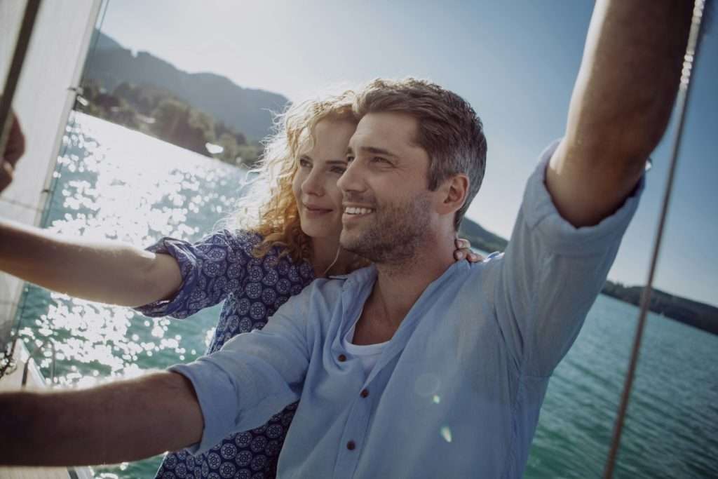 happy couple on a sailing boat